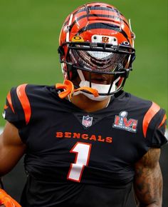 a football player wearing an orange and black uniform