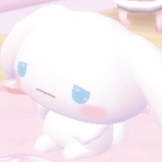 an animated image of a white bunny sitting on the ground in front of a pink wall