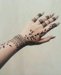 a woman's hand with tattoos on it