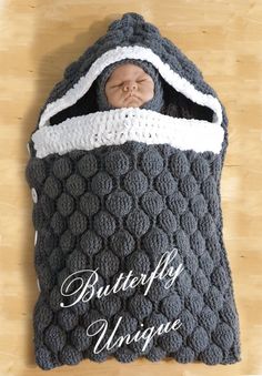 a baby wrapped in a crochet blanket with the words butterfly wings written on it