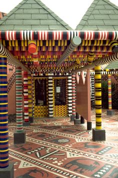 an array of multicolored columns in a courtyard