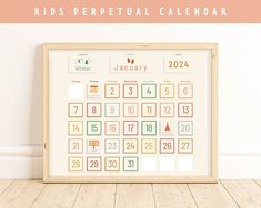 a kids's personal calendar is displayed in front of a wooden frame on the floor