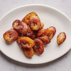 a white plate topped with bananas on top of a table