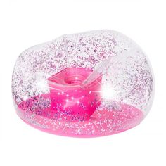 a pink and white snow globe with sparkles on the top, in front of a white background