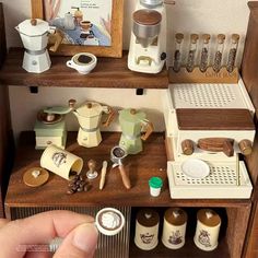 a miniature kitchen set with coffee maker, blender and other items on the shelf