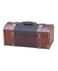 a brown and blue leather trunk with two straps on the top, sitting in front of a white background