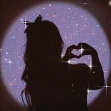 the silhouette of a woman making a heart with her hands in front of a purple background