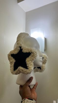 someone is holding up a stuffed star hat