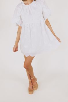 This white embroidered floral mini dress is the epitome of romantic elegance. Featuring a delicate scallop hemline and ruffle lace details, it is the perfect addition to any summer wardrobe. Enhance your feminine charm and steal hearts wherever you go with this beautiful dress. Details Round neckline Keyhole closure Ruffle lace details Embroidered fabricaiton Scallop hemline Lined Pockets Sizing Approximate measurements: SIZE LENGTH BUST WAIST Small 33” 36” 36” Medium 33” 38” 38” Large 34” 40” 4 Summer Brunch Dresses With Scalloped Edges, Feminine Ruffled Lace Dress For Garden Party, Feminine Lace Dress With Ruffles For Garden Party, Feminine Lace Dress With Ruffles For Brunch, Lace Mini Dress With Scalloped Edges, Summer Wedding Lace Dress With Ruffle Hem, Chic Floral Embroidered Mini Dress For Wedding, Summer Daywear Dress With Scalloped Lace, Spring Day Dresses With Scalloped Edges