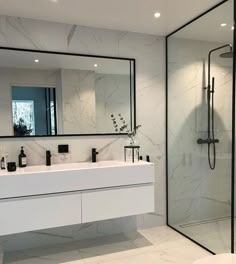 a modern bathroom with marble walls and floor