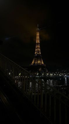 the eiffel tower is lit up at night