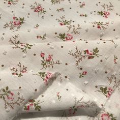 white fabric with pink flowers and polka dots