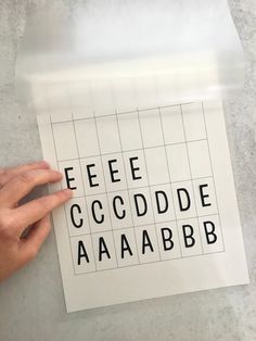 a person is holding up a piece of paper with the words eeeee occddde aaaaabb