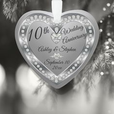 an ornament shaped like a heart on a christmas tree with the words 10th wedding anniversary