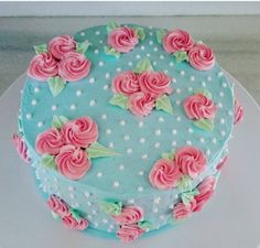 a blue cake with pink flowers on it