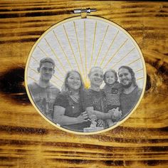 the family is posing for a photo in front of a wooden frame with sunbursts on it