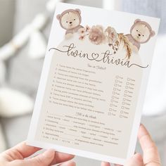 someone holding up a baby shower checklist with teddy bears on it's back