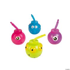 four toys with different colors and designs on them, one has a straw in the mouth