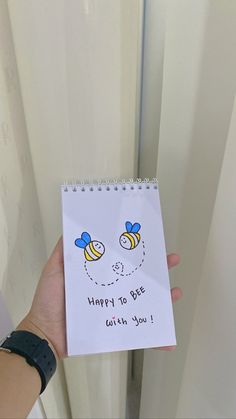 a hand holding up a note that says happy to bee with you