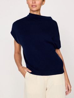 In a luxe 100% cashmere, this modern vest/top is designed to be worn on its own or layered as a vest. Featuring a draped funnel neck, rounded dropped shoulders and a relaxed shape, this sleeveless sweater is the epitome of effortlessness and versatility. Part of our ‘Kinder To The Environment’ collection, it is made RWS-certified, traceable yarn which means it adheres to stringent animal welfare standards. Relaxed fit Draped funnel neckline Sleeveless Rounded dropped shoulders Ribbed back neck, Vince Funnel Neck Sweater Coastal, Luxury Funnel Neck Top With Ribbed Cuffs, Luxury Funnel Neck Top For Workwear, Luxury Classic Funnel Neck Outerwear, Luxury Oversized Tops With Funnel Neck, Luxury Black Funnel Neck Top, Luxury Funnel Neck Sweater, Luxury Chic Merino Wool Knit Top, Luxury Beige Funnel Neck Sweater