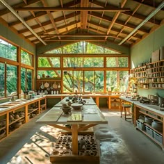 Discover the charm of our workshop room, a spacious studio combining wood and green clay, nestled in nature. High ceilings, abundant windows, and serene forest views create an inspiring setting for creativity. Central to the room, a large island table and shelves are stocked with pottery tools and ceramic materials, perfect for crafting and exploration. Outside Pottery Studio, Pottery Studio Architecture, Large Island Table, Art Studio Set Up, Pottery Studio Interior Design, Ceramic Studio Layout, Materiality Architecture, Craft Room Set Up, Pottery Studio Aesthetic