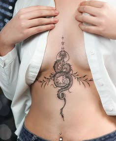 a woman with a snake tattoo on her stomach