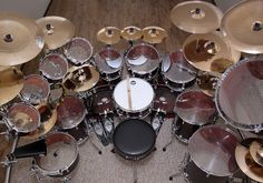 an overhead view of a drum set and cymbals in a room with wood floors