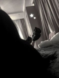 a black and white photo of a bedroom with stars on the ceiling