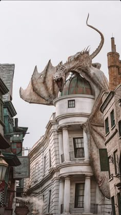 a giant dragon statue on the side of a building