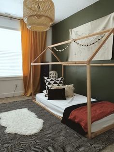 a bedroom with green walls and white bedding