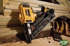 a cordless drill is laying on some wood