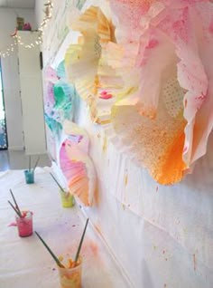 the wall is covered with paper flowers and paint