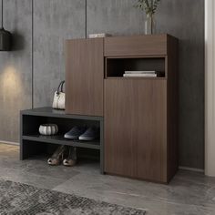 a wooden cabinet with shoes on it next to a lamp and rug in a room