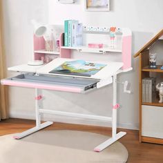 a white and pink desk with books on it