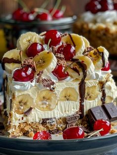 a piece of cake on a plate with cherries and banana slices in the middle