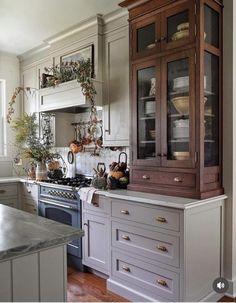 a kitchen with an oven, cabinets and counter tops in grey paint on the walls