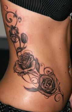 a woman with a rose tattoo on her stomach