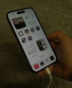 someone is holding an iphone with several icons on it