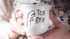 a woman holding a coffee mug with the words tea and prex written on it