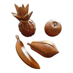 three pieces of wood carved to look like fruit