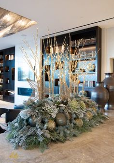 a living room filled with lots of furniture and christmas decorations on top of a table