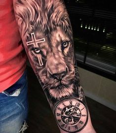 a man with a lion tattoo on his arm holding a cross and a clock in front of him