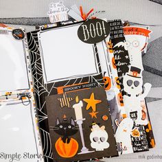 an open halloween scrapbook with black and orange accents