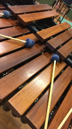 several wooden mallets lined up on top of each other