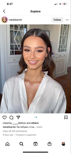 a woman with long dark hair wearing a white shirt and looking at the camera on her instagram