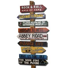 a wooden sign post with many different signs on it's sides and the words rock & roll, stairway to heaven, highway to hell, abbey road to hell,