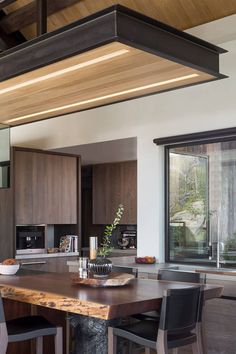 a wooden table sitting in the middle of a kitchen