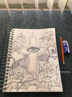 a notebook with an eye and roses drawn on it