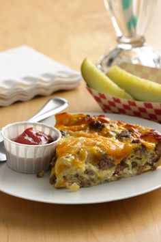 a slice of quiche on a plate with ketchup