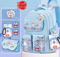 the back pack is blue with cartoon characters on it and has two tags attached to it